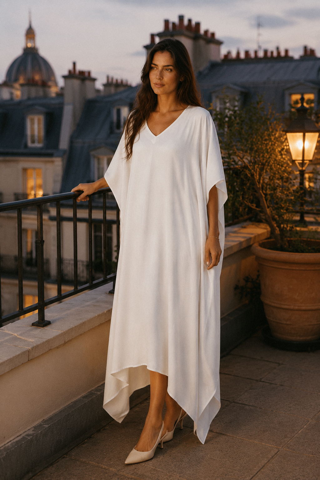 White cotton caftan maxi dress, lifestyle, relaxed moment in a sunlit courtyard