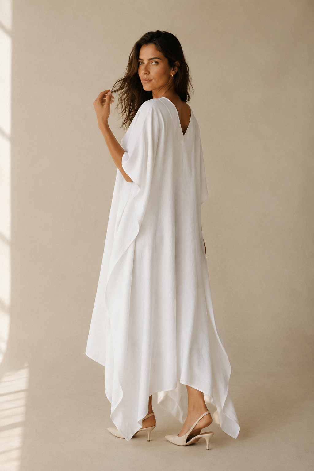 White cotton caftan maxi dress, three-quarter view, draped fabric and wide kimono sleeves