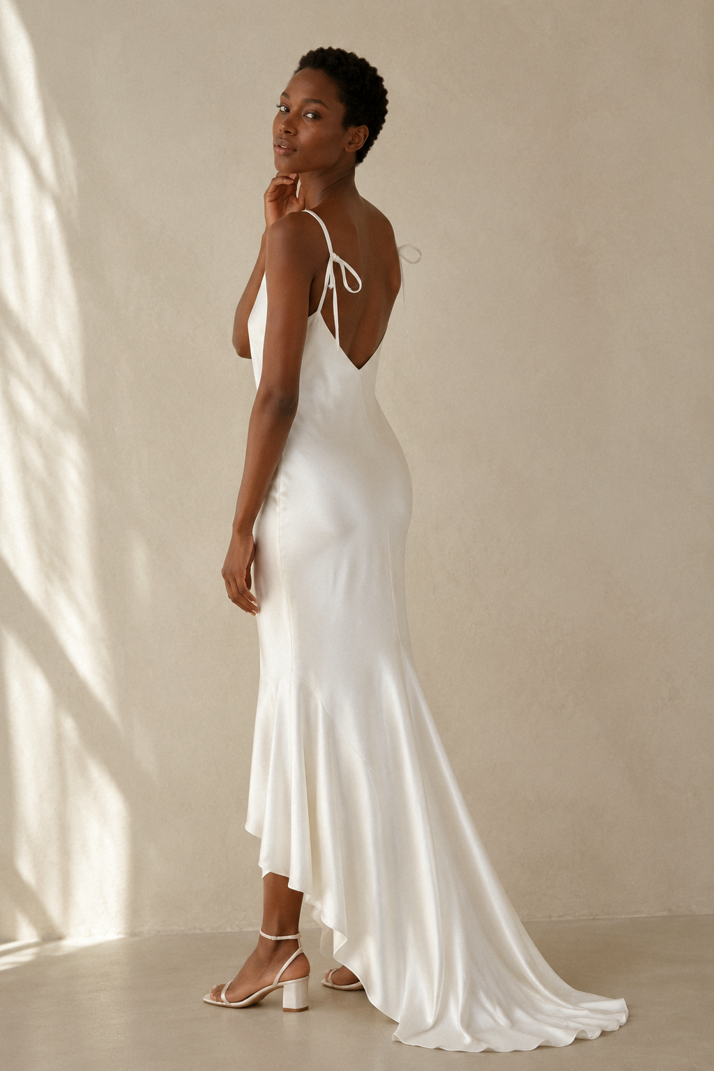 White silk slip maxi dress, three-quarter view, fabric drape and side slit