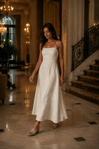 Ivory linen a-line maxi dress, lifestyle, sunlit courtyard, gentle afternoon