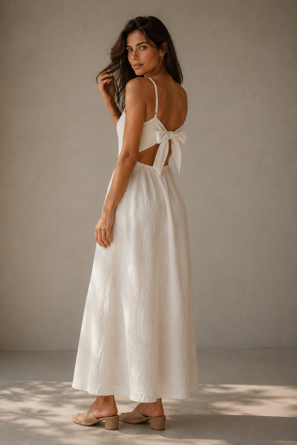 Ivory linen a-line maxi dress, three-quarter view, back tie detail and flowing maxi skirt