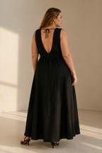 Black linen trapeze maxi dress, back view, deep V back, delicate tie