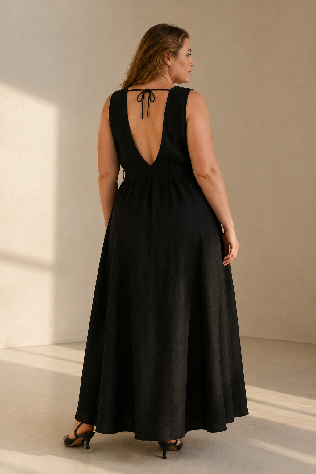 Black linen trapeze maxi dress, back view, deep V back, delicate tie