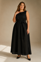Black linen trapeze maxi dress, full front view, simple round neck, flowing silhouette