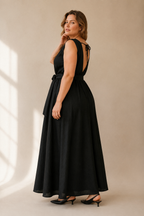 Black linen trapeze maxi dress, three-quarter view, flowing maxi length, wide hem