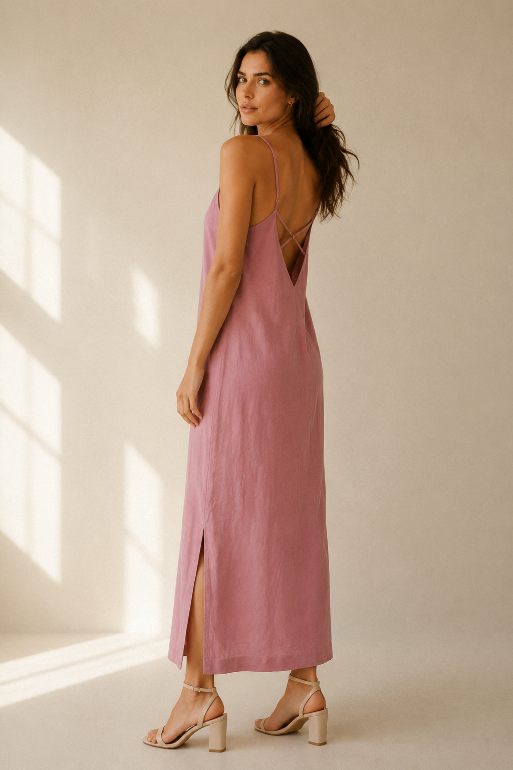 Dusty pink linen slip maxi dress, three-quarter view, crisscross back straps, side slit