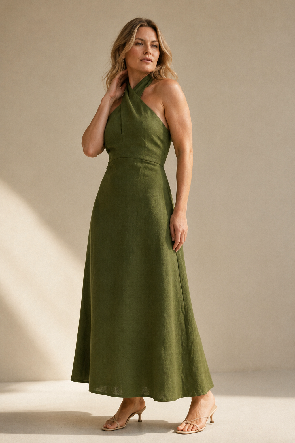 Olive green linen a-line maxi dress, three-quarter view, fluid skirt and relaxed posture