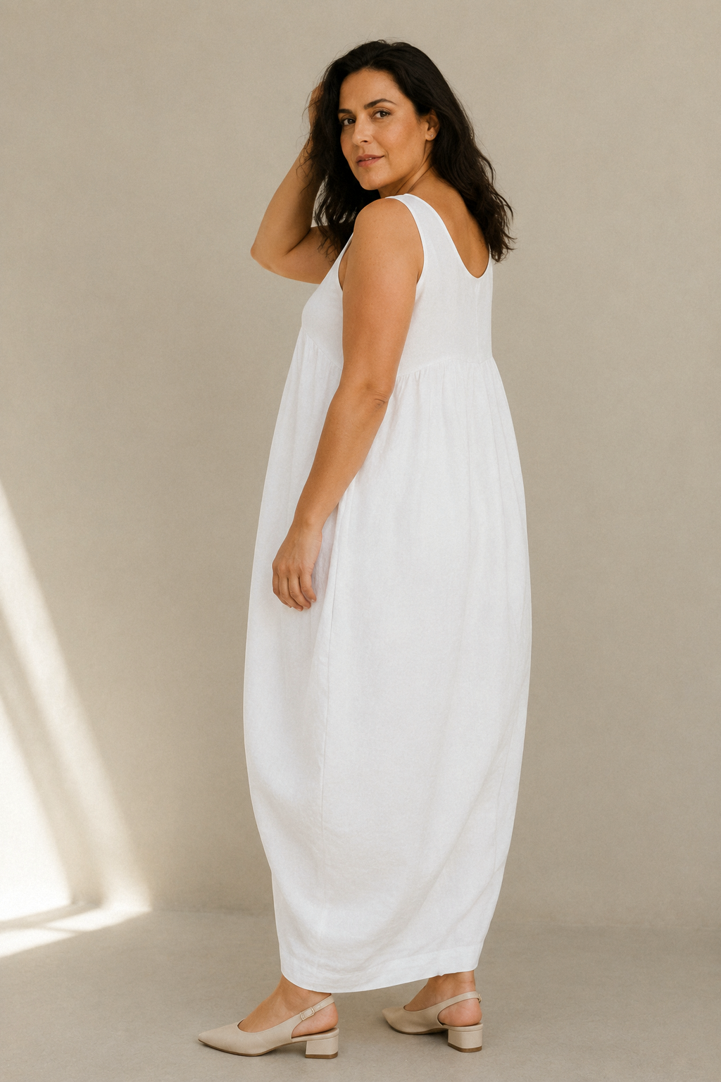 White linen cocoon maxi dress, three-quarter view, relaxed fit and flowing fabric