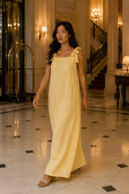 Butter yellow linen shift maxi dress, lifestyle, soft light by an archway