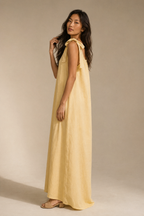 Butter yellow linen shift maxi dress, three-quarter view, loose drape and full length