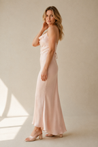 Pale pink silk slip maxi dress, three-quarter view, gentle fabric drape and flattering line