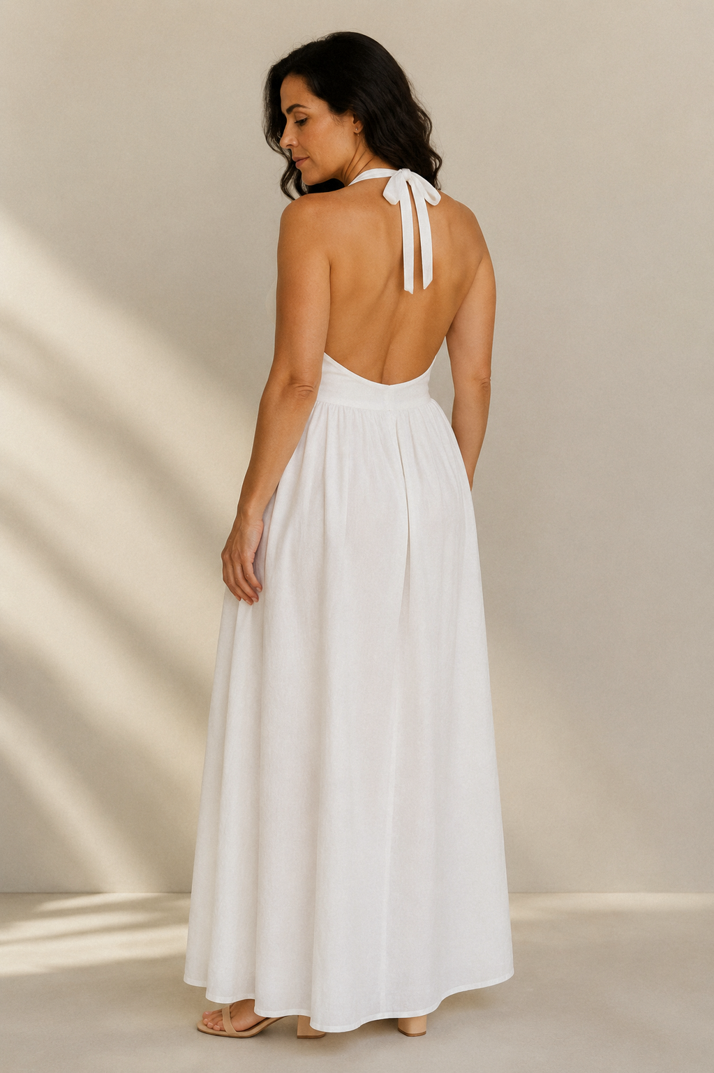 White linen a-line maxi dress, back view, halter neck straps