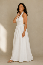 White linen a-line maxi dress, three-quarter view, flowing skirt and cinched waist