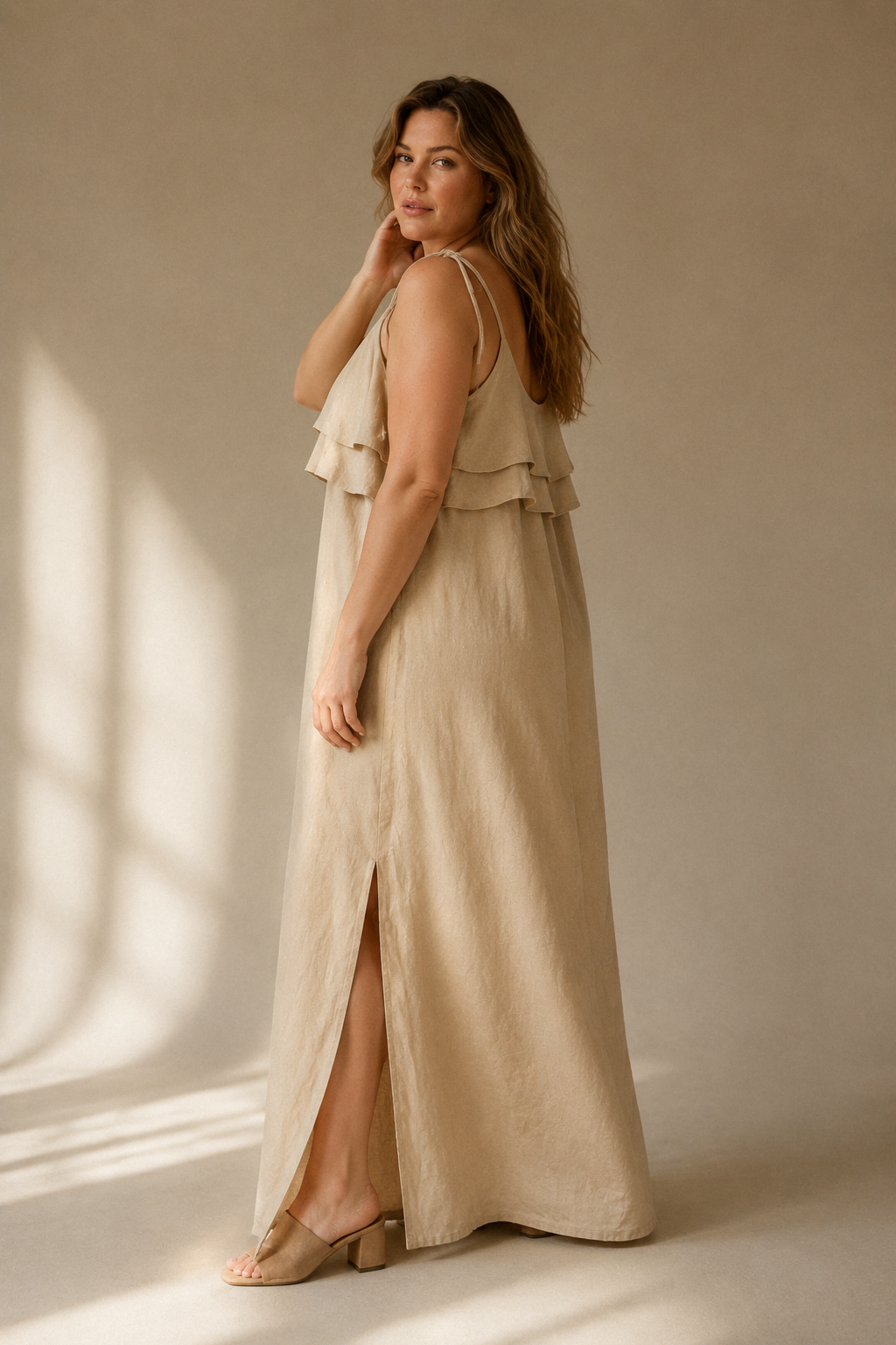 Beige linen shift maxi dress, three-quarter view, flowing linen and tiered detail