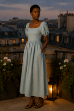 Light blue linen a-line maxi dress, lifestyle, quiet morning light at home