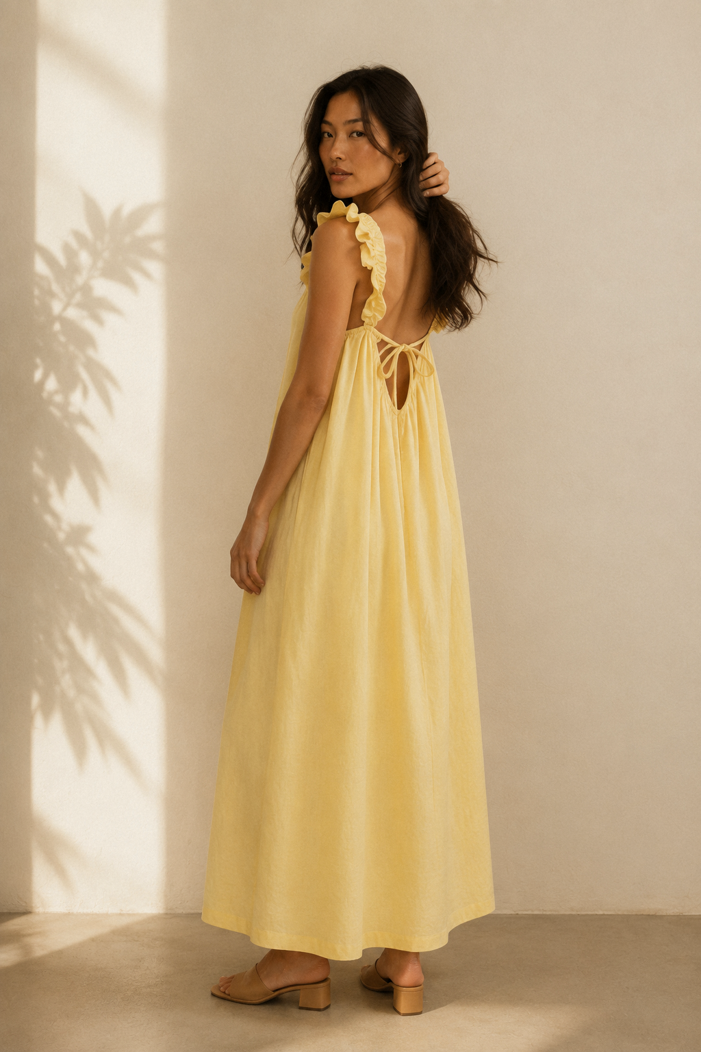 Butter yellow linen a-line maxi dress, three-quarter view, open back with tie closure