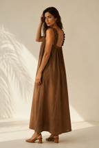 Brown linen a-line maxi dress, three-quarter view, relaxed volume and ruffled shoulder details