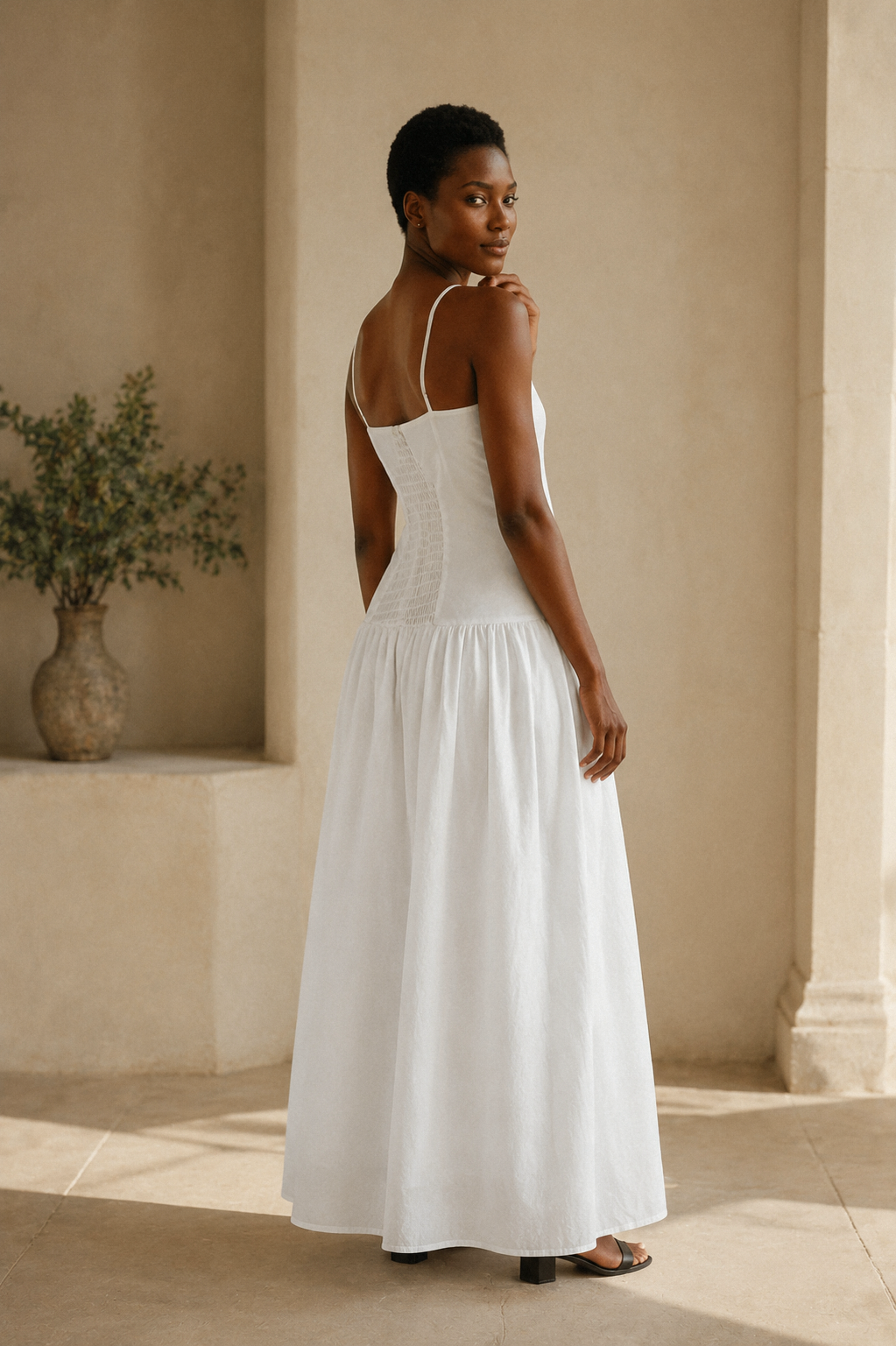 White cotton a-line maxi dress, three-quarter view, clean lines and flowing skirt