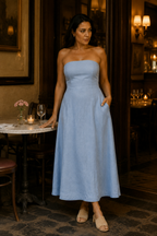 Light blue linen a-line maxi dress, lifestyle, sunlit archway, relaxed elegance
