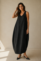 Black linen cocoon maxi dress, full front view, relaxed V-neck and flowing, rounded silhouette