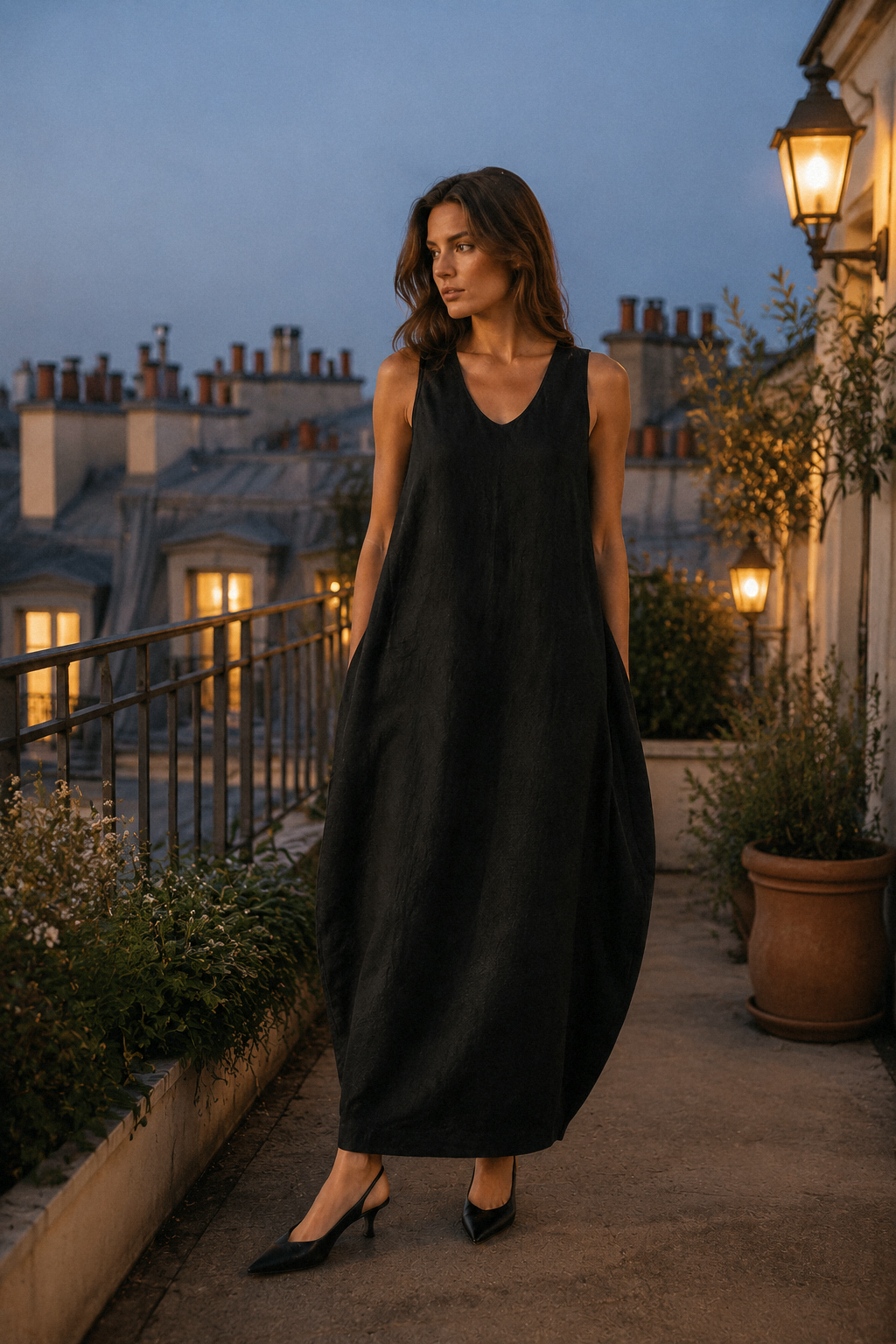 Black linen cocoon maxi dress, lifestyle, strolling in warm light, casual elegance