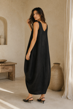Black linen cocoon maxi dress, three-quarter view, voluminous drape and deep armholes