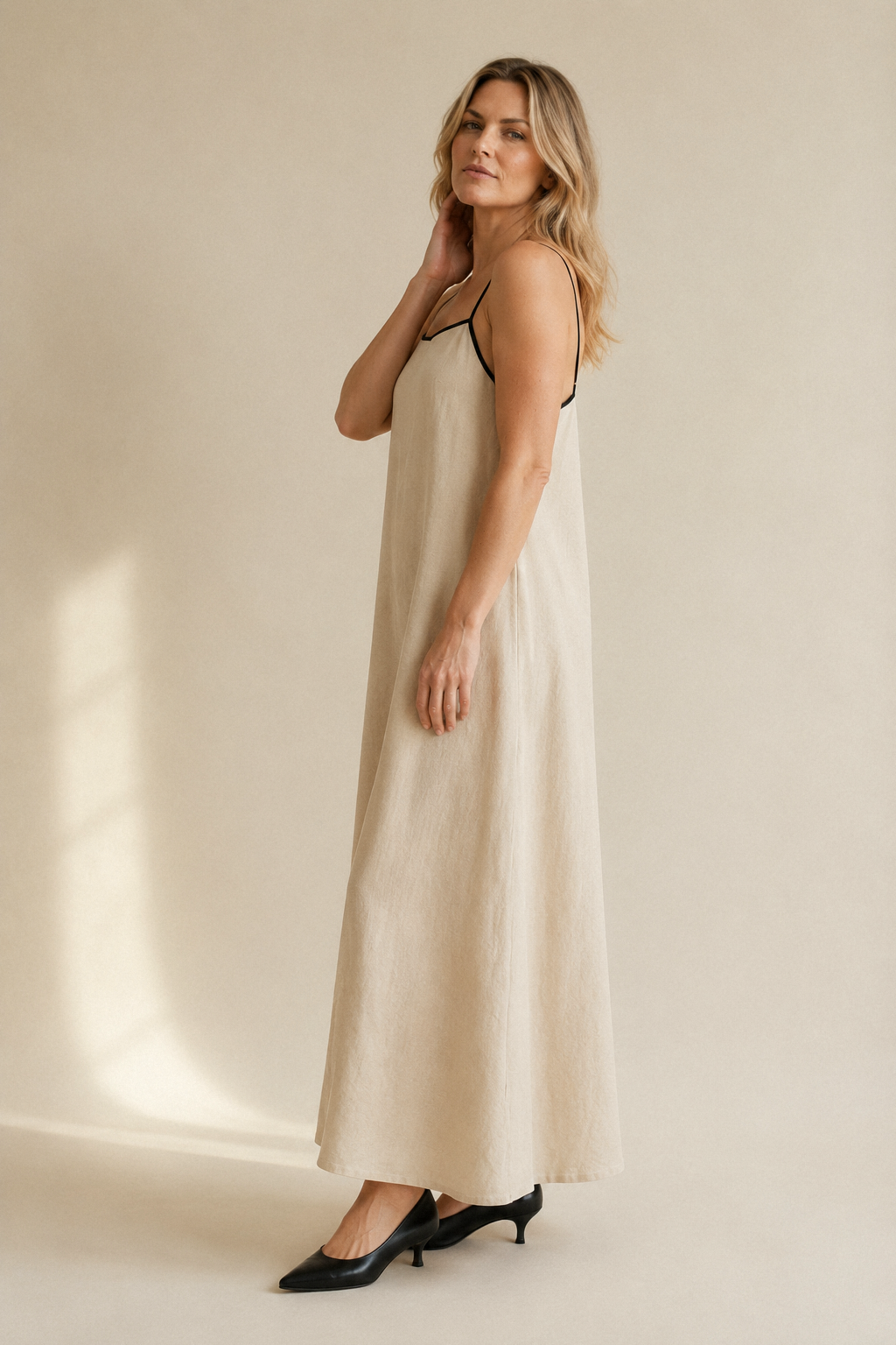 Beige linen slip maxi dress, three-quarter view, flowing skirt and light fabric
