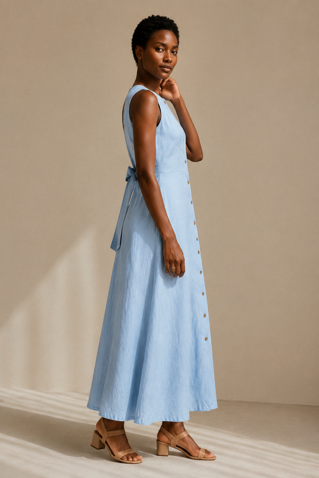 Light blue linen a-line maxi dress, three-quarter view, natural linen drape and button detail