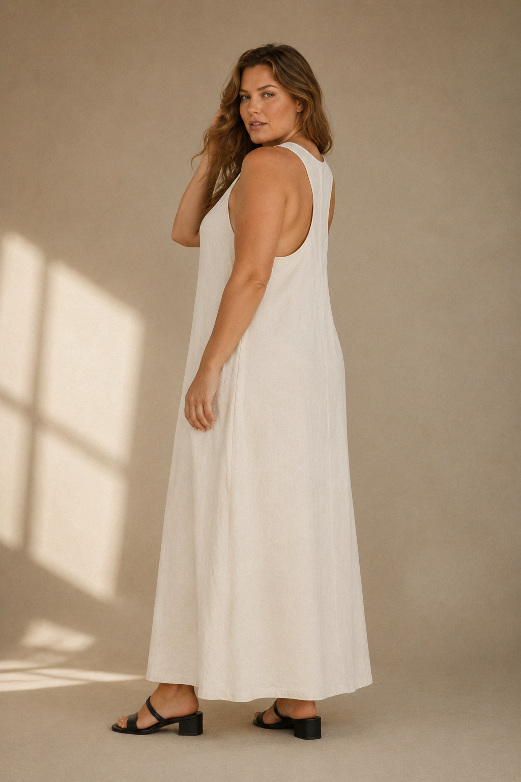 Ivory linen shift maxi dress, three-quarter view, relaxed drape with side pockets