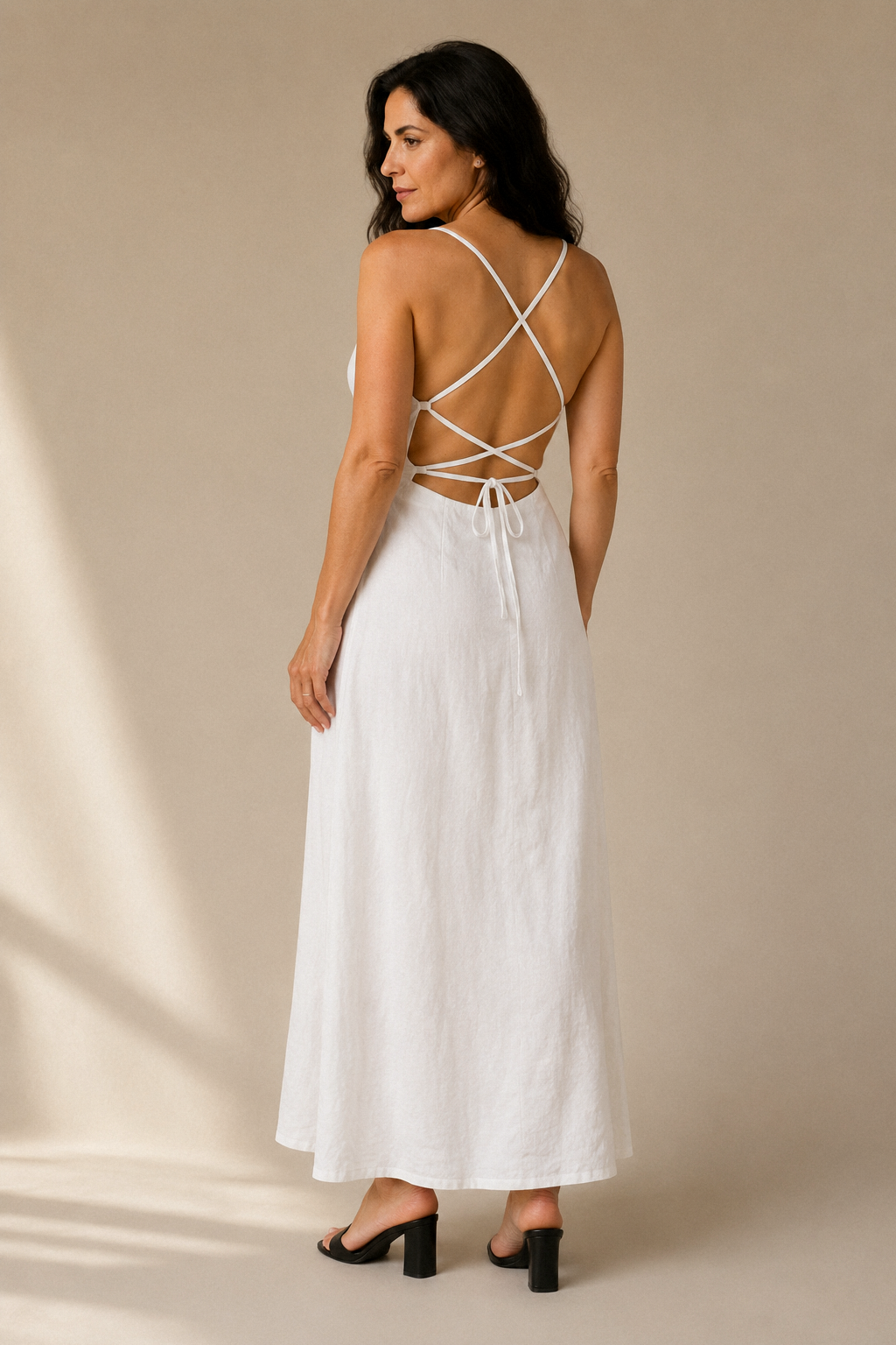 White linen a-line maxi dress, back view, criss-cross tie back