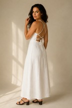 White linen a-line maxi dress, three-quarter view, open back and flowing skirt