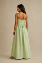 Light green linen a-line maxi dress, back view, fitted bodice, soft skirt release
