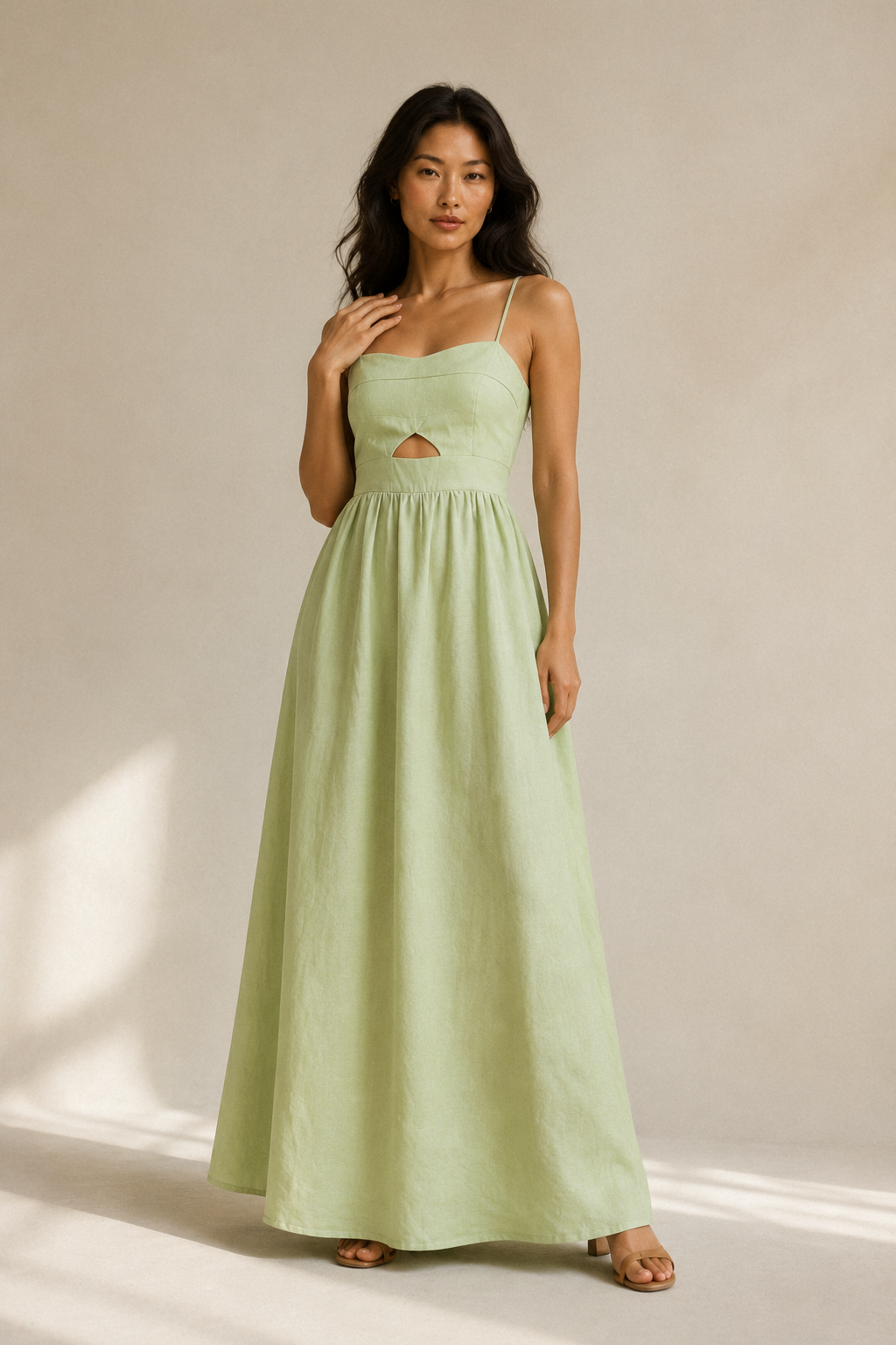 Light green linen a-line maxi dress, full front view, spaghetti straps, waist cut-out, full maxi skirt