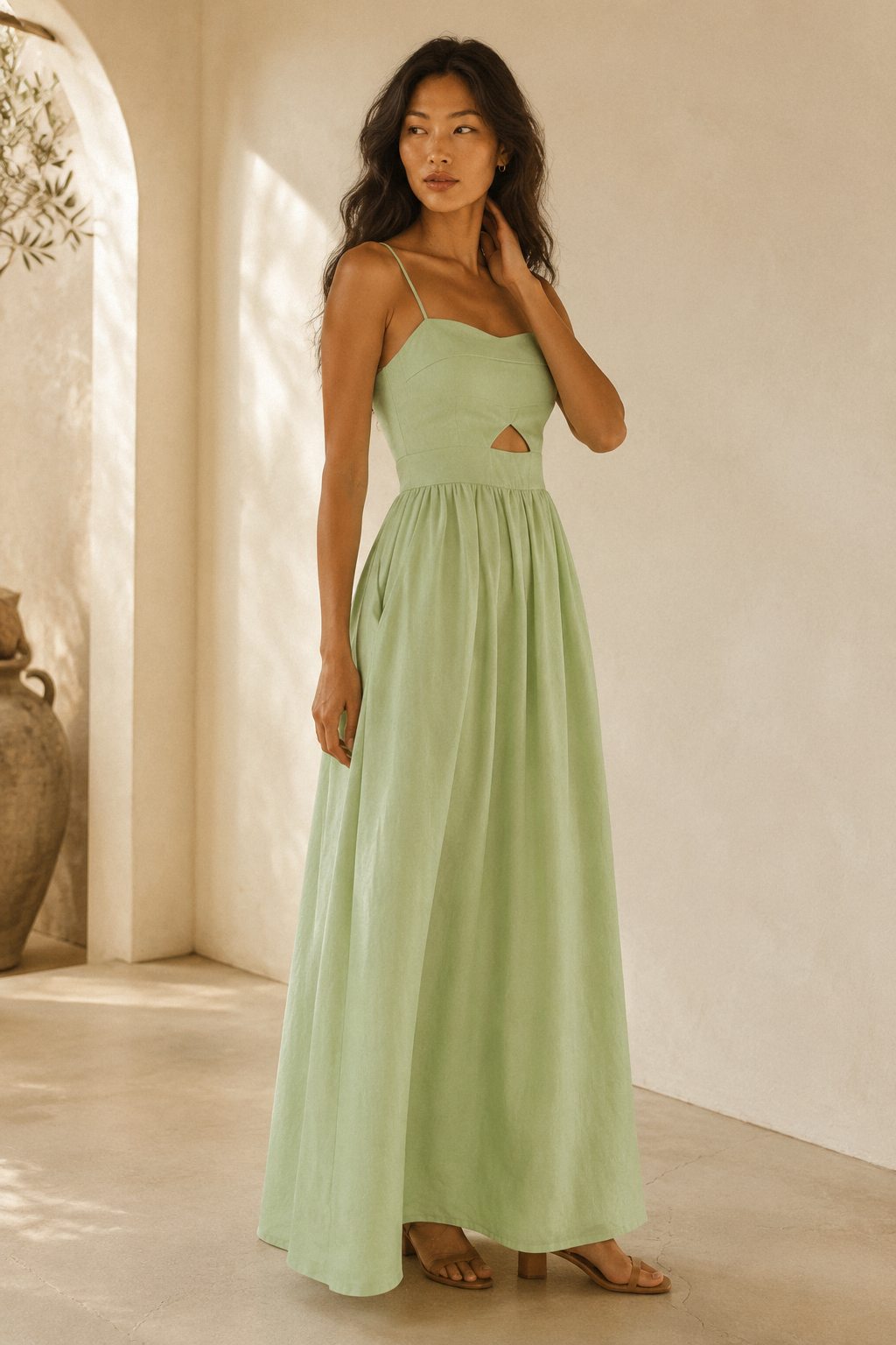 Light green linen a-line maxi dress, three-quarter view, flowing skirt drape, side pockets, casual sandals