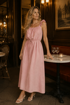 Light pink linen shift maxi dress, lifestyle, smiling in sunlit, minimalist setting