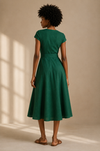 Emerald linen wrap midi dress, back view, fitted waist and skirt sweep