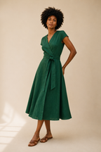 Emerald linen wrap midi dress, three-quarter view, wrap silhouette and fabric drape