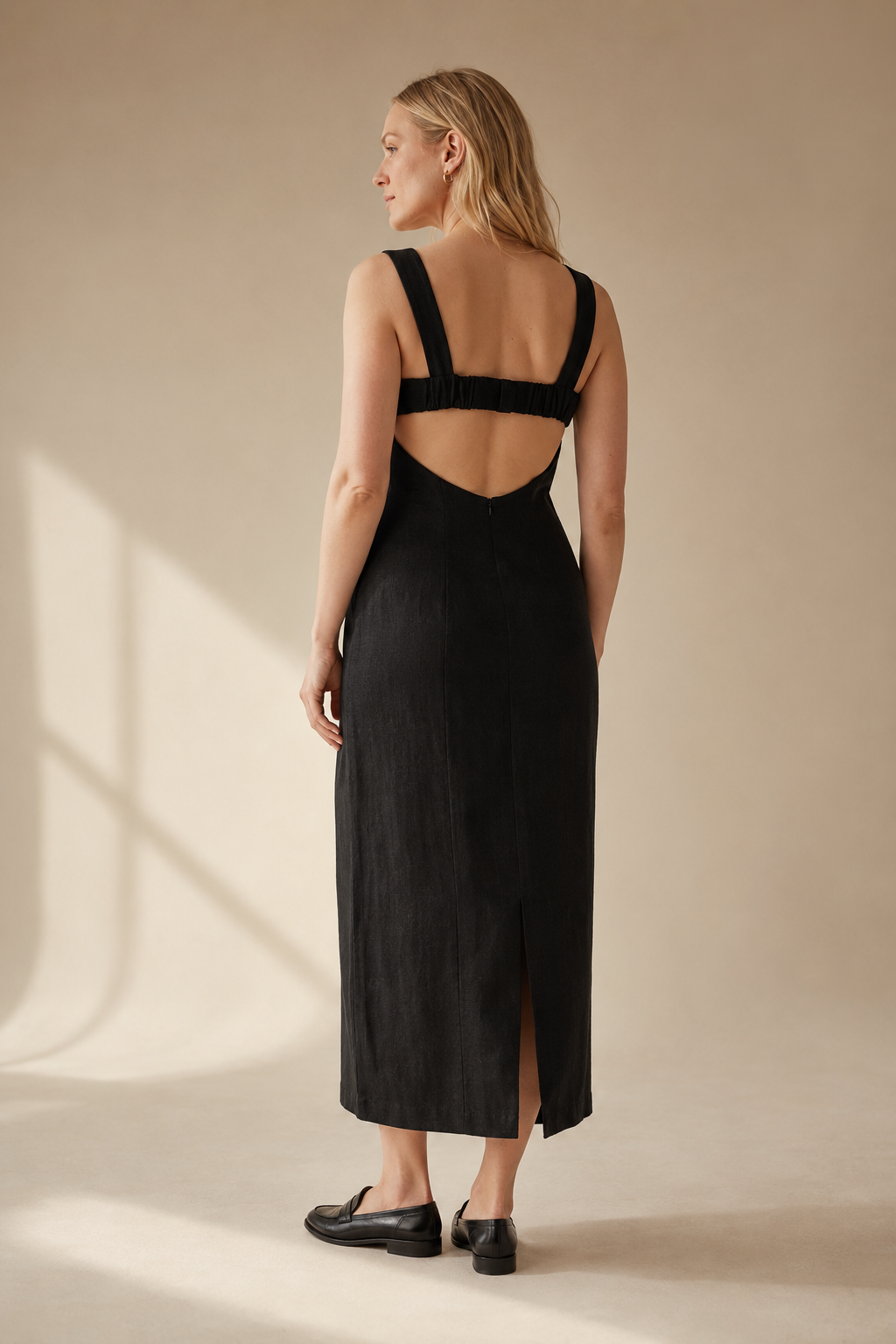 Black linen column midi dress, back view, open back with elasticated strap detail