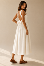Ivory cotton a-line midi dress, three-quarter view, back bow and flowing midi skirt