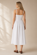White linen a-line midi dress, back view, fitted bodice and flowing skirt