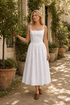 White linen a-line midi dress, lifestyle, sunny courtyard stroll