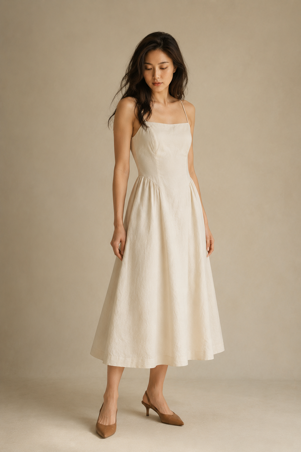 Ivory linen a-line midi dress, three-quarter view, deep scoop back, thin straps, gathered skirt