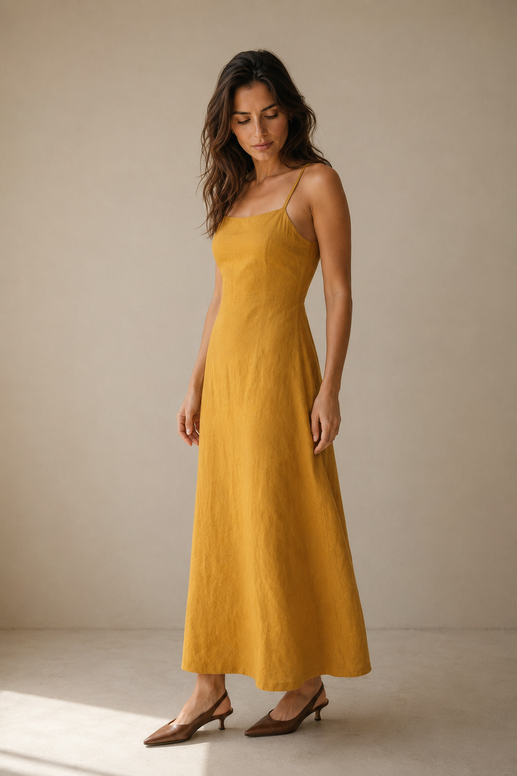 Mustard yellow linen a-line midi dress, three-quarter view, skirt movement and fabric texture