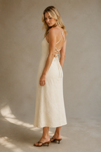 Ivory linen column midi dress, three-quarter view, column silhouette, back tie detail, natural linen