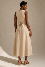 Beige linen a-line midi dress, back view, clean back, gentle waist seam
