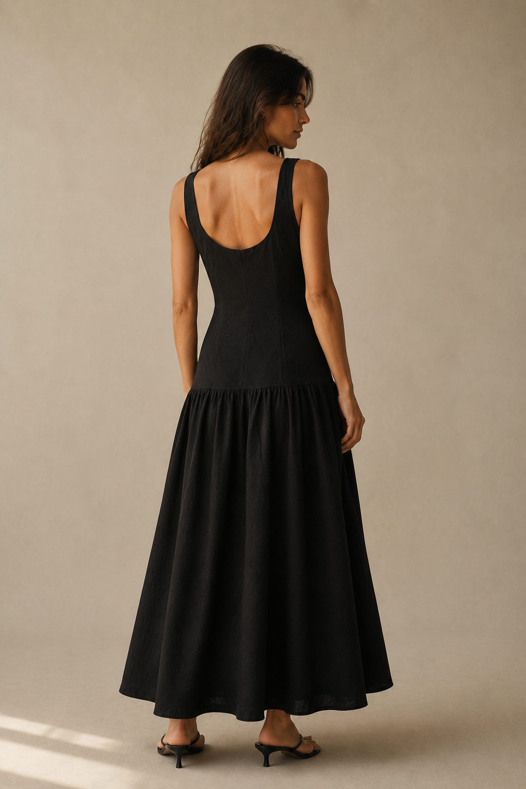 Black linen a-line midi dress, back view, u-shaped back and soft skirt release