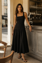 Black linen a-line midi dress, lifestyle, strolling through sunlit courtyards