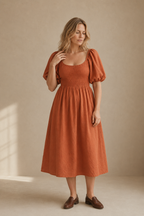 Rust orange linen a-line midi dress, full front view, smocked bodice and full A-line skirt