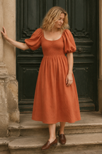 Rust orange linen a-line midi dress, front view, square neckline, smocked bodice, puff sleeves