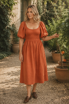 Rust orange linen a-line midi dress, lifestyle, quiet moment in soft light